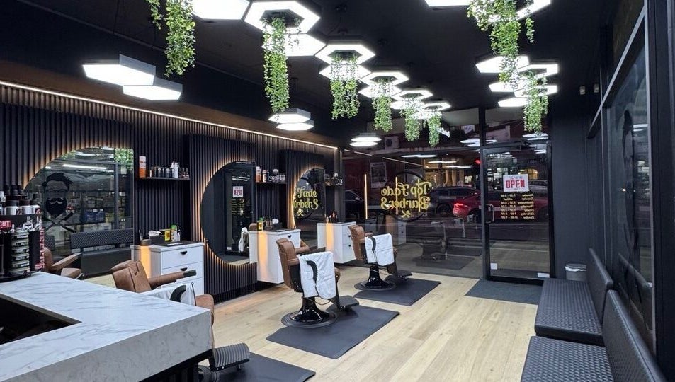 Modern interior of Top Fade Barbers Ivanhoe, Melbourne, Victoria, AU, showcasing sleek black and white design.