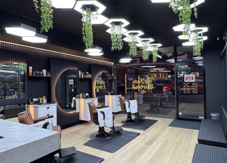 Modern interior of Top Fade Barbers Ivanhoe, Melbourne, Victoria, AU, showcasing sleek black and white design.