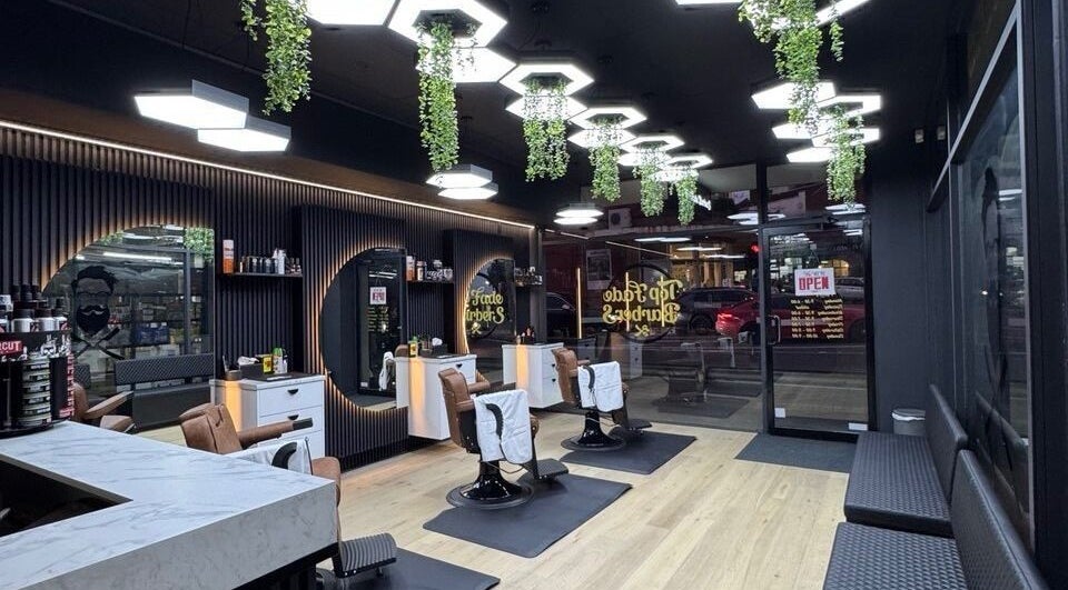 Modern interior of Top Fade Barbers Ivanhoe, Melbourne, Victoria, AU, showcasing sleek black and white design.
