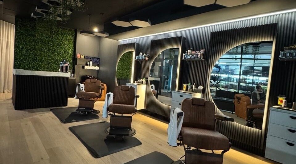 Interior of Top Fade Barbers Ivanhoe with chic decor, Melbourne, Victoria, AU. Stylish barber chairs and mirrors.