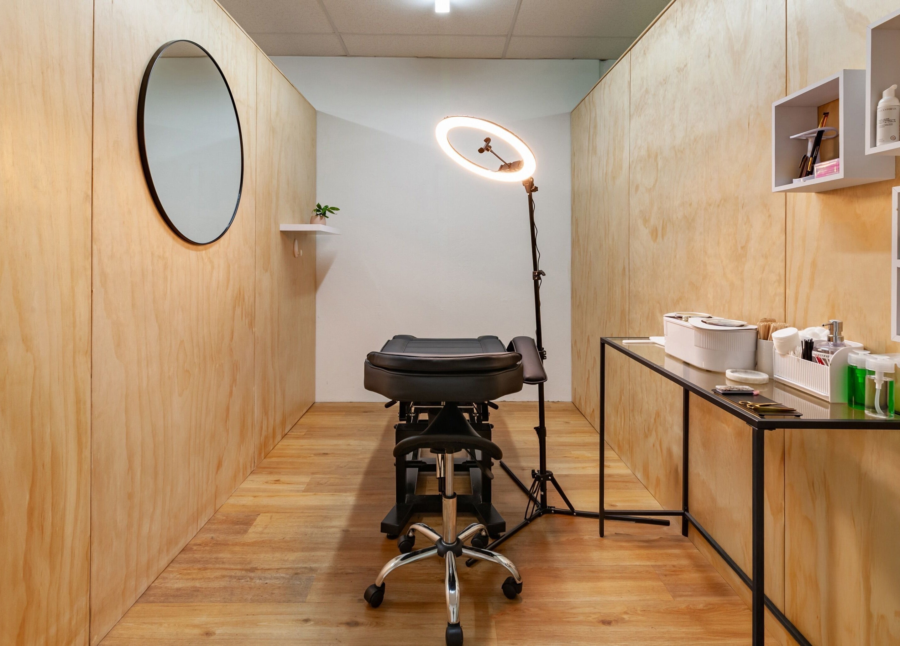 Boutique treatment room at Brows Defined in Christchurch, Waitaha, NZ with modern furnishings and lighting.