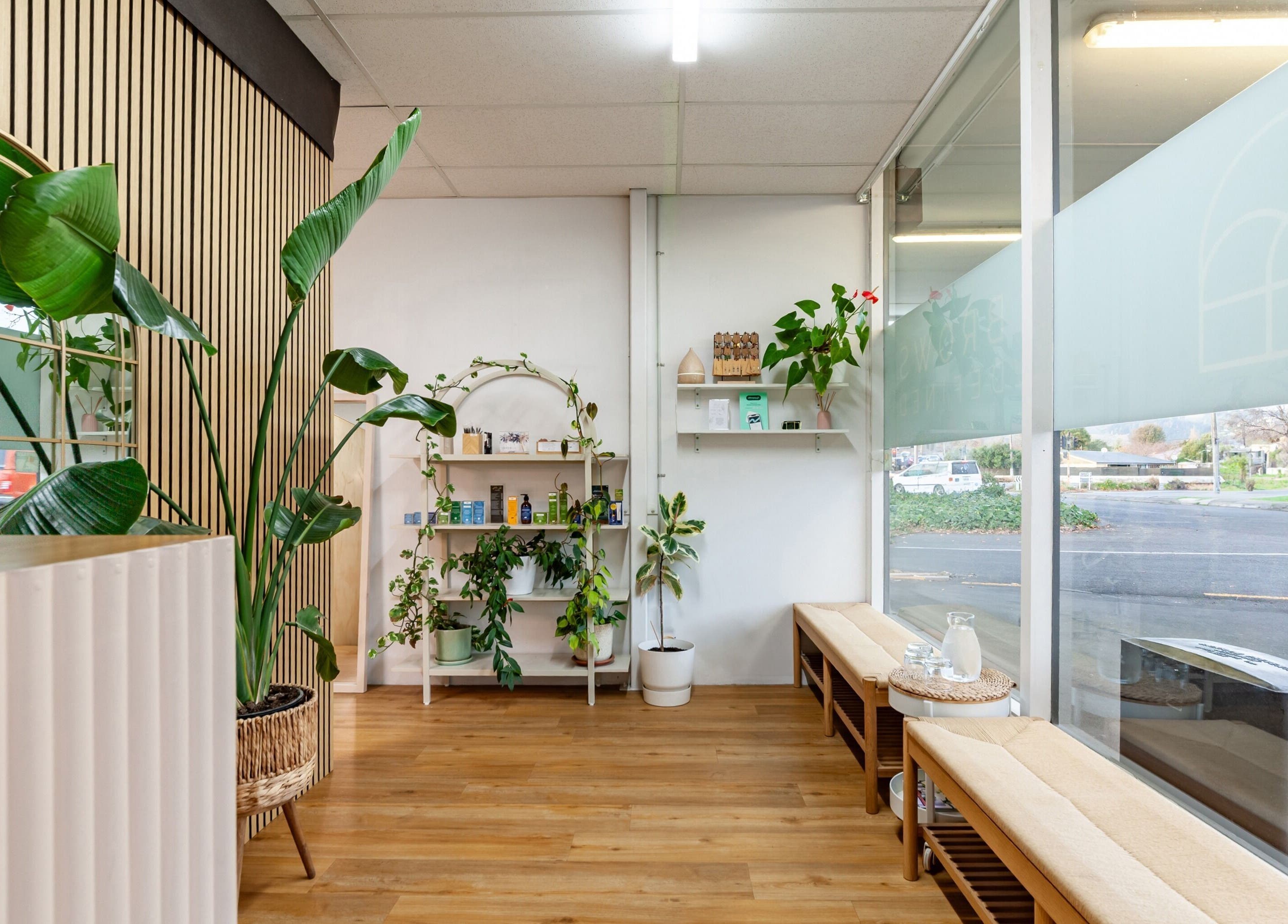 Welcoming interior of Brows Defined in Christchurch, Waitaha, NZ, featuring lush plants and modern decor.
