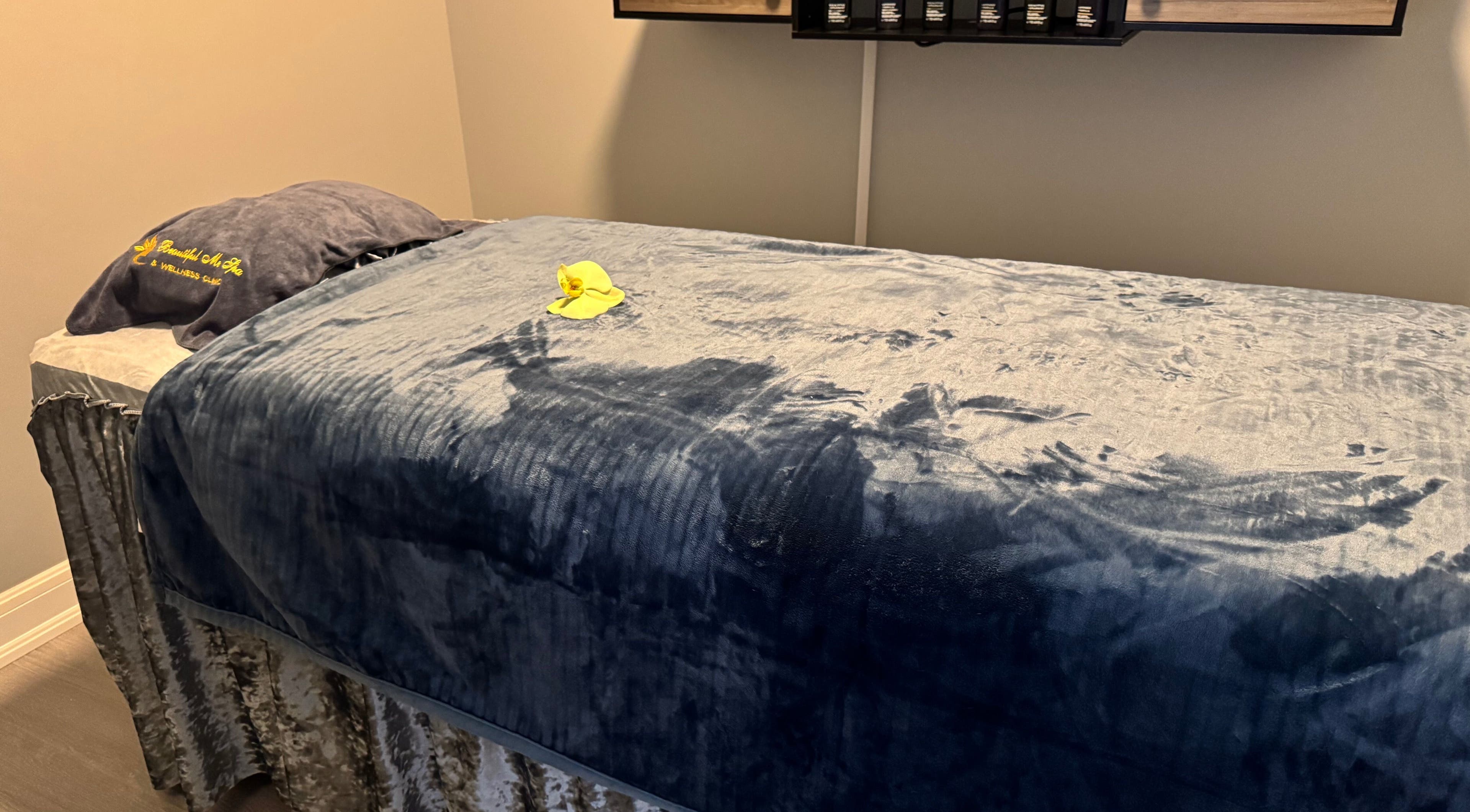 Relaxing spa treatment room at Beautiful Me Spa & Wellness Clinic, Toronto, Ontario, CA with plush blue bedding.