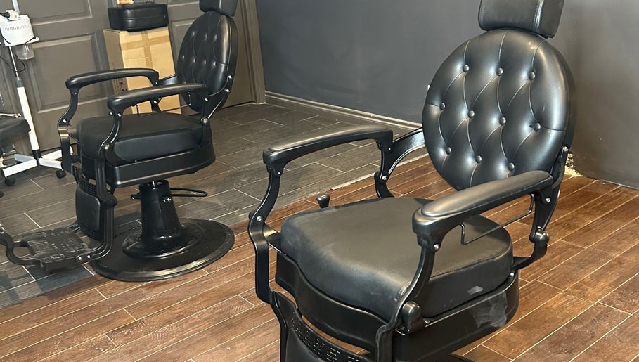 Luxurious barber chair at FadedByJass in Edmonton, Alberta, CA, highlighting sleek design and comfort.