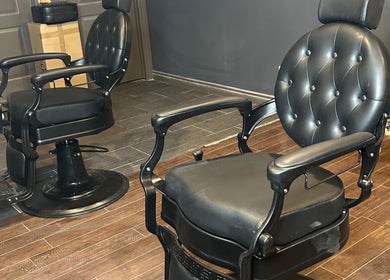 Luxurious barber chair at FadedByJass in Edmonton, Alberta, CA, highlighting sleek design and comfort.