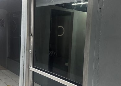 Zlaynails entrance with sleek glass facade in San-Fernando, TT, highlighting a chic beauty atmosphere.