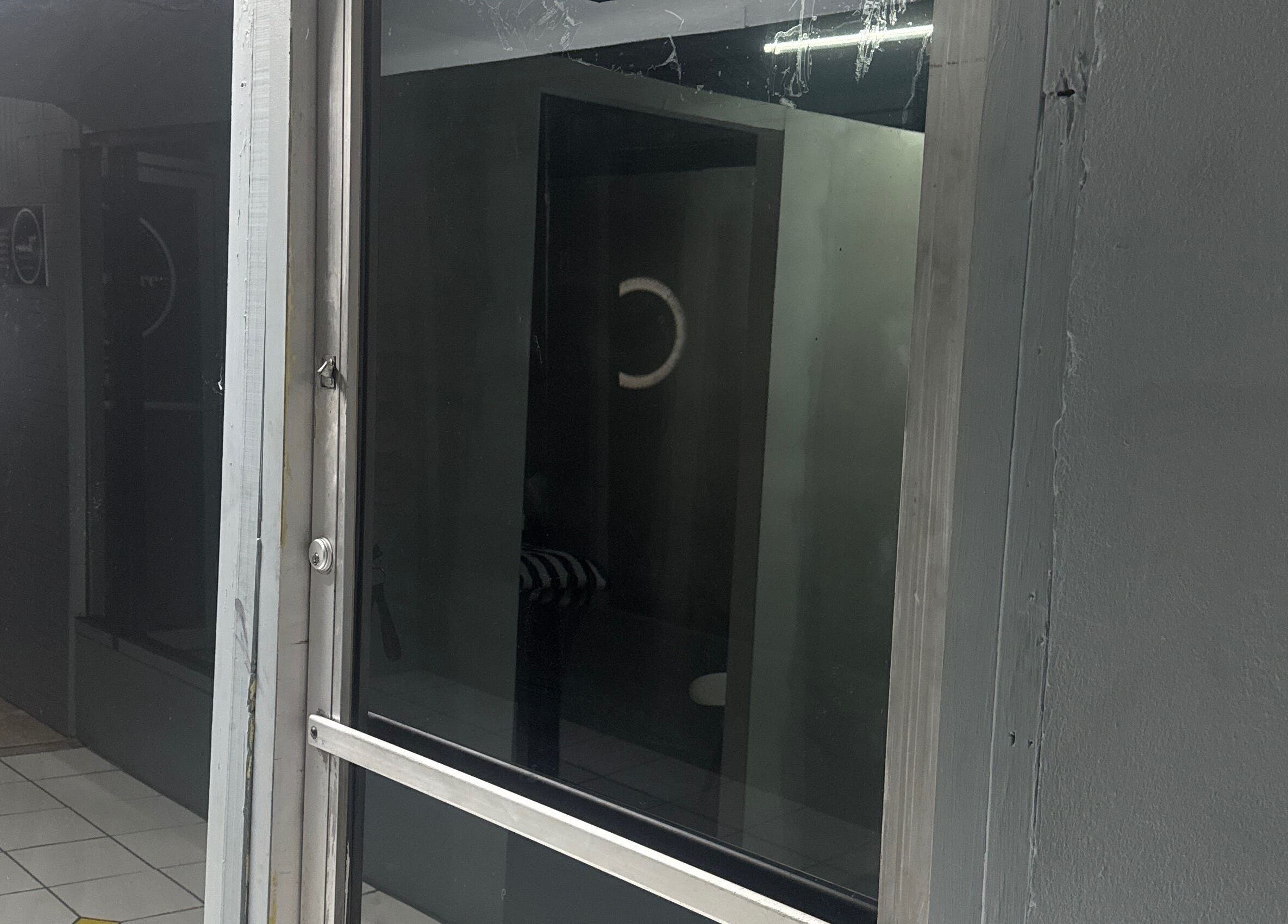 Zlaynails entrance with sleek glass facade in San-Fernando, TT, highlighting a chic beauty atmosphere.