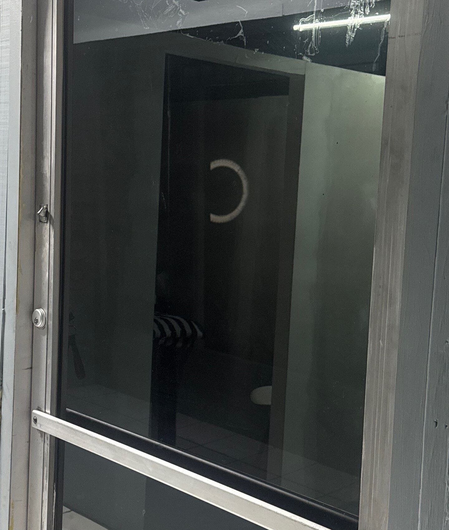 Zlaynails entrance with sleek glass facade in San-Fernando, TT, highlighting a chic beauty atmosphere.