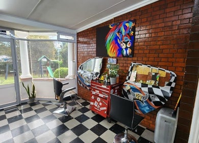 Modern interior of Blu Gel Hair Studio, Pietermaritzburg, Kwazulu-natal, ZA with colorful decor and stylish chairs.