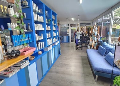 Blu Gel Hair Studio's modern interior in Pietermaritzburg, Kwazulu-natal, ZA showcasing stylish seating and products.