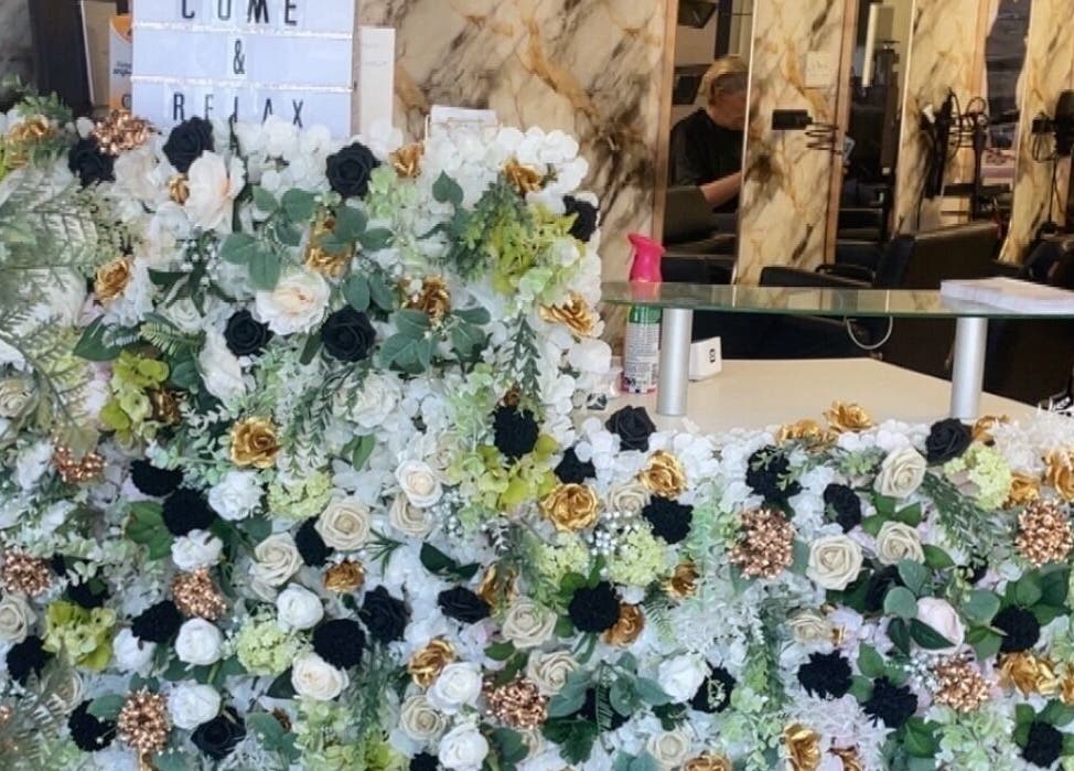 Reception desk adorned with flowers at Slay Studios NE, North Shields, England, GB, offering a warm welcome.