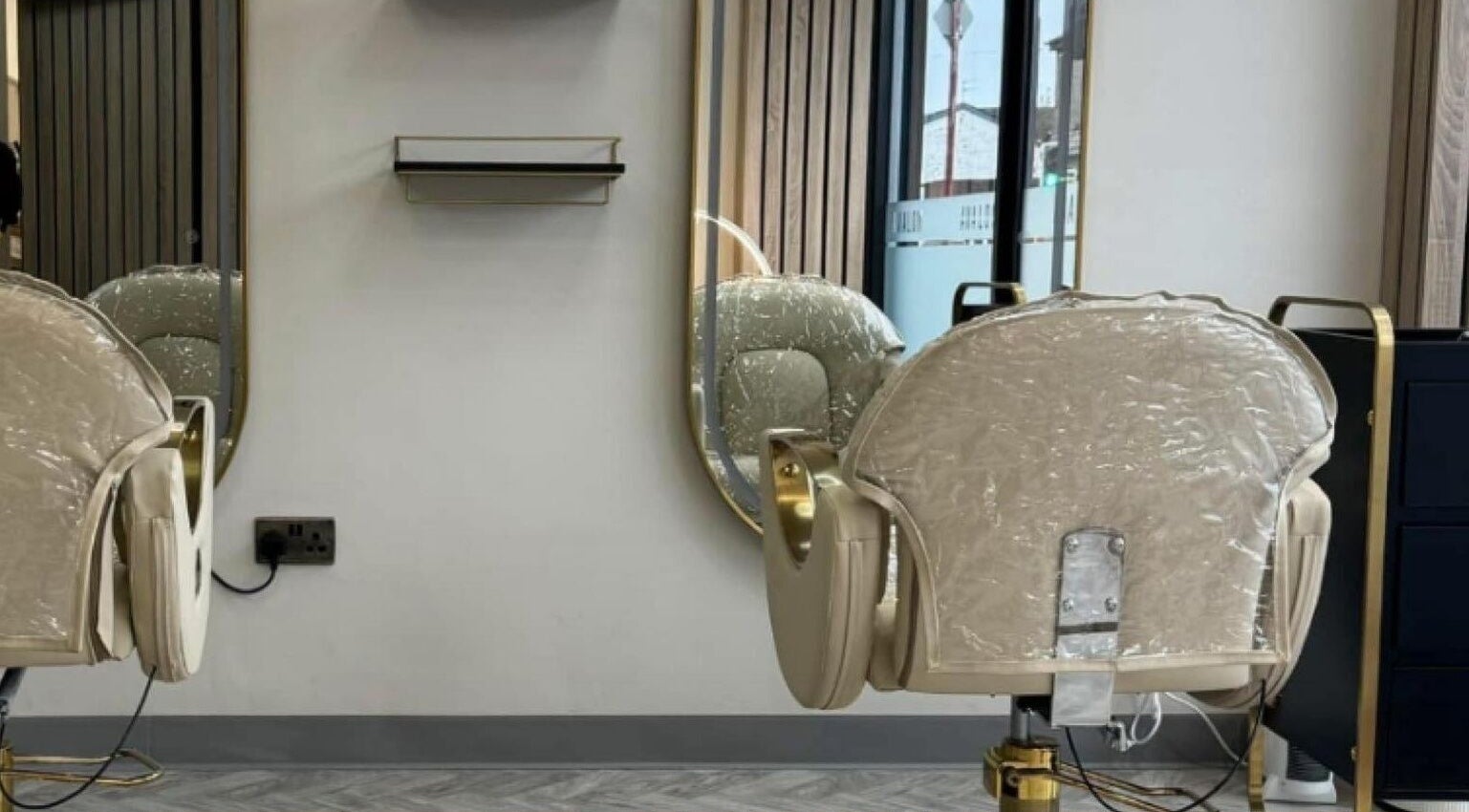 Modern salon chair and mirror at Avalon Hair And Beauty Station, Droylsden, England, GB.