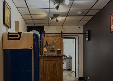 Rustic interior of Rudys Barbershop in St Helier, GB with vintage decor and warm ambiance.