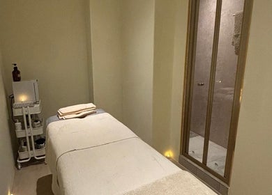 Tranquil massage room at The Celine Spa, Swanley, England, GB with a cozy treatment bed and ambient lighting.