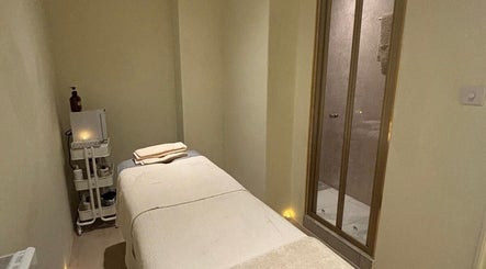 Tranquil massage room at The Celine Spa, Swanley, England, GB with a cozy treatment bed and ambient lighting.