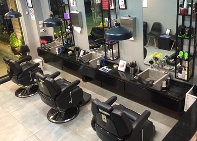 Interior of Capital Barber (صالون العاصمة) in Amman, featuring sleek barber chairs and stylish decor.