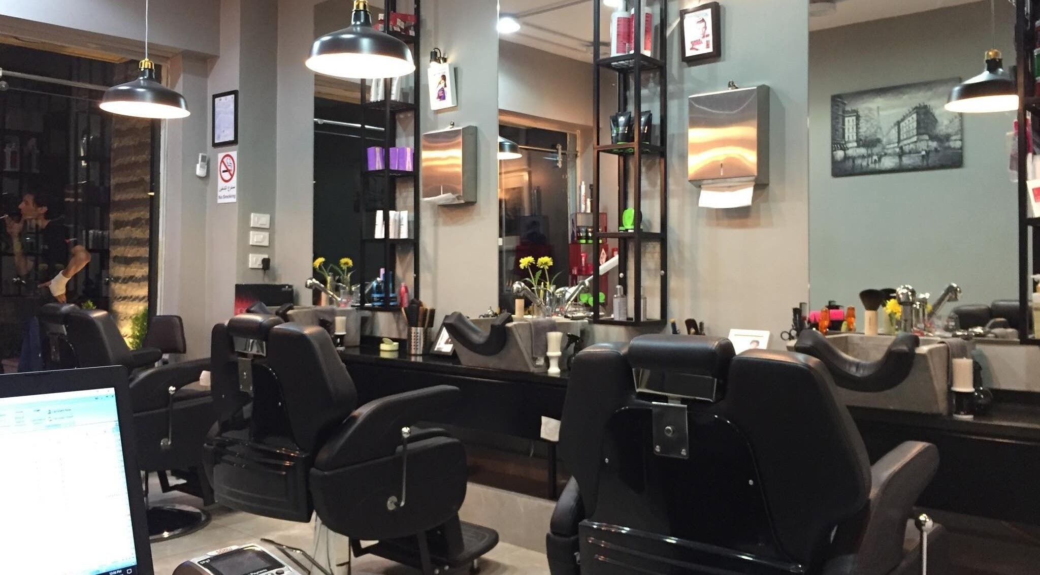 Modern interior of Capital barber (صالون العاصمة) in Amman, featuring stylish chairs and elegant decor.