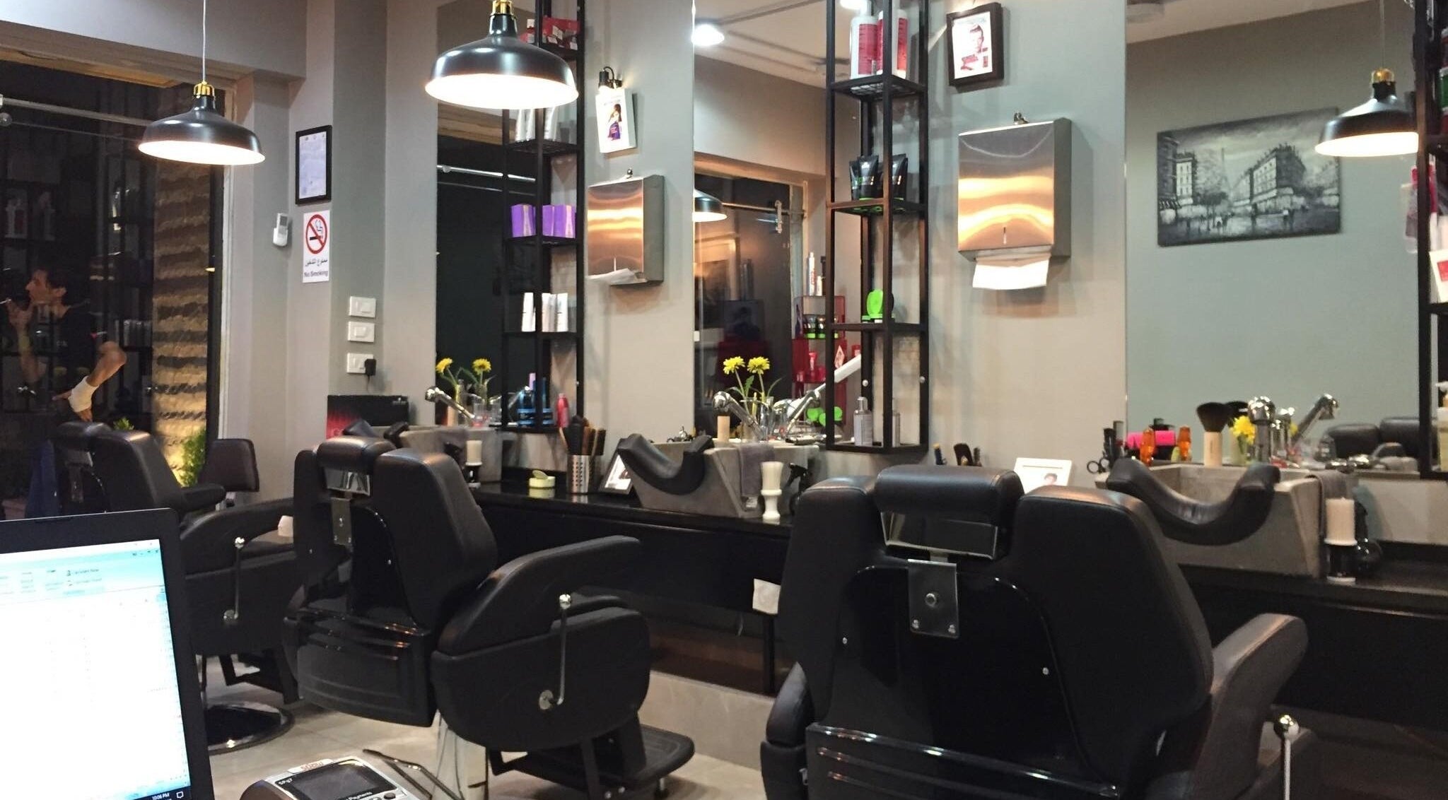 Modern interior of Capital barber (صالون العاصمة) in Amman, featuring stylish chairs and elegant decor.