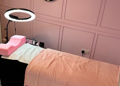 Comfortable pink beauty treatment bed at Petal Beauty by Lydia, Derby, England, GB, ready for clients.