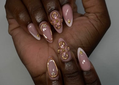 Elegant nail art at By Shanice, Falmouth, Trelawny Parish, JM. Features pink nails with gold and floral accents.