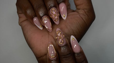 Elegant nail art at By Shanice, Falmouth, Trelawny Parish, JM. Features pink nails with gold and floral accents.