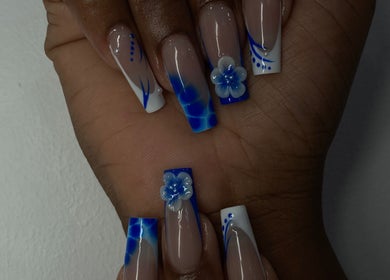 Elegant blue floral nail art at By Shanice, Falmouth, Trelawny Parish, JM. Perfect for a chic, modern look.