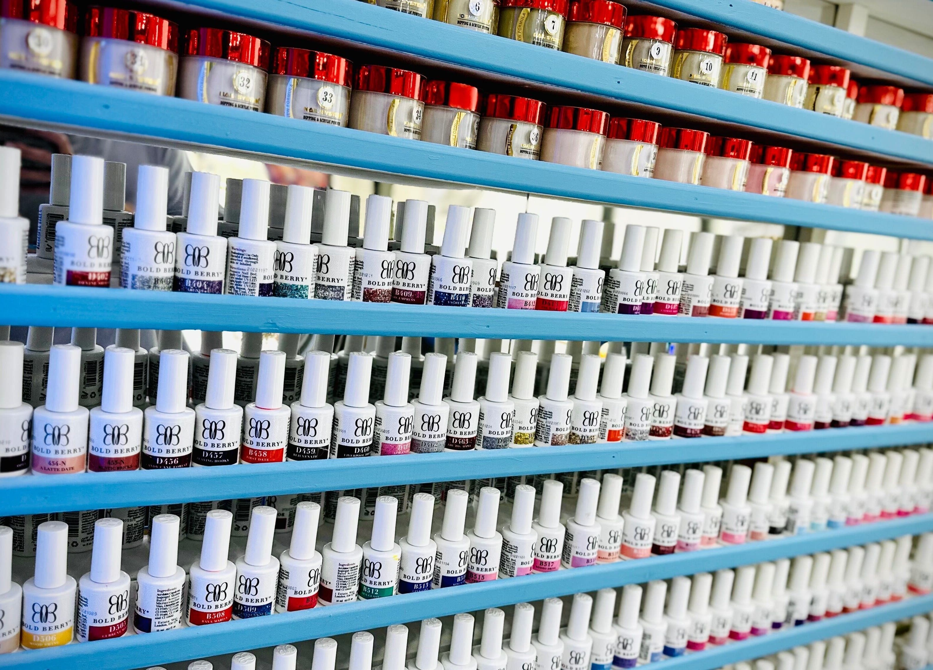Vibrant nail polish display at Ocean Nails spa, Airdrie, Scotland, GB, showcasing diverse color selection.