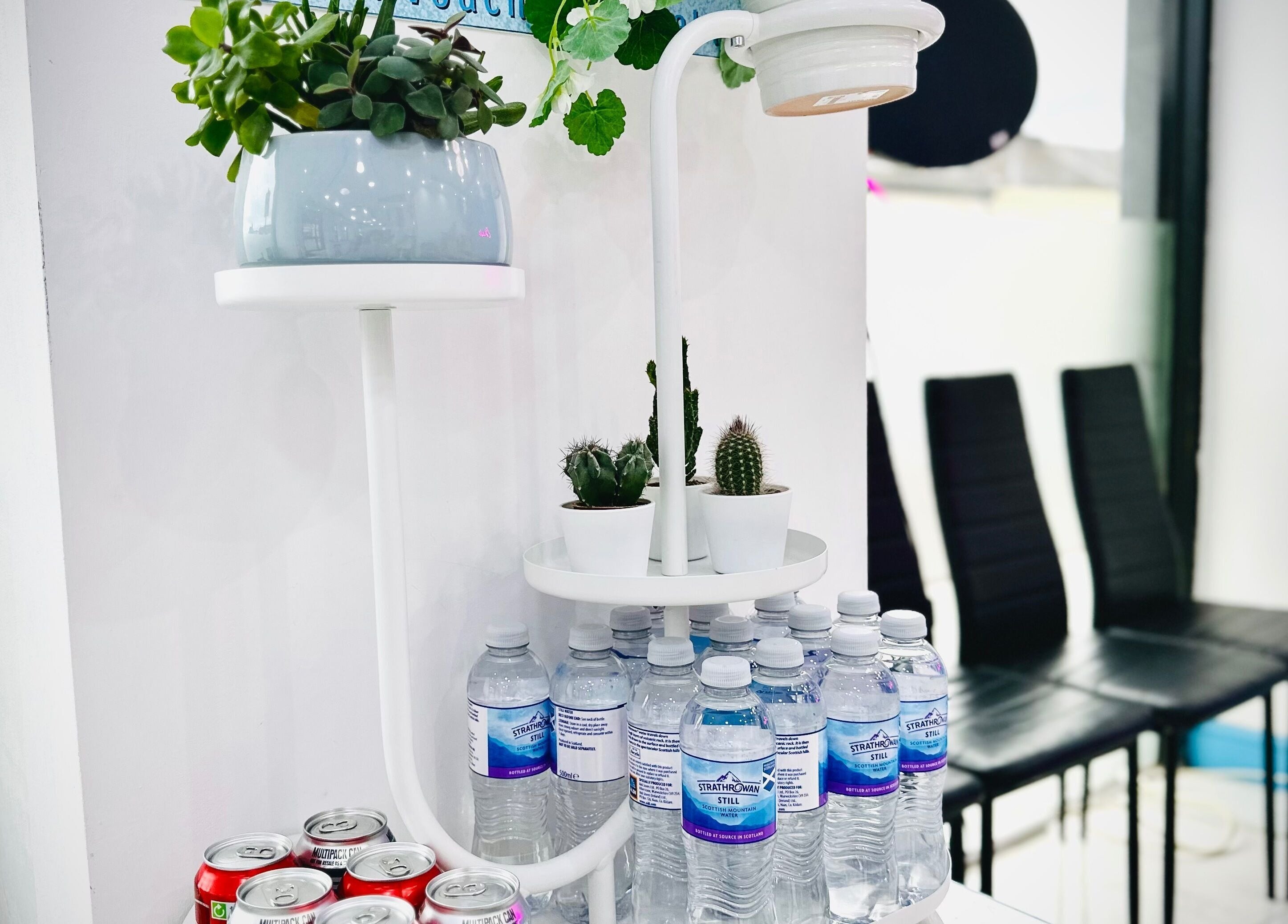 Ocean Nails spa in Airdrie, Scotland, GB offers a stylish refreshment station with drinks and plants for guests.