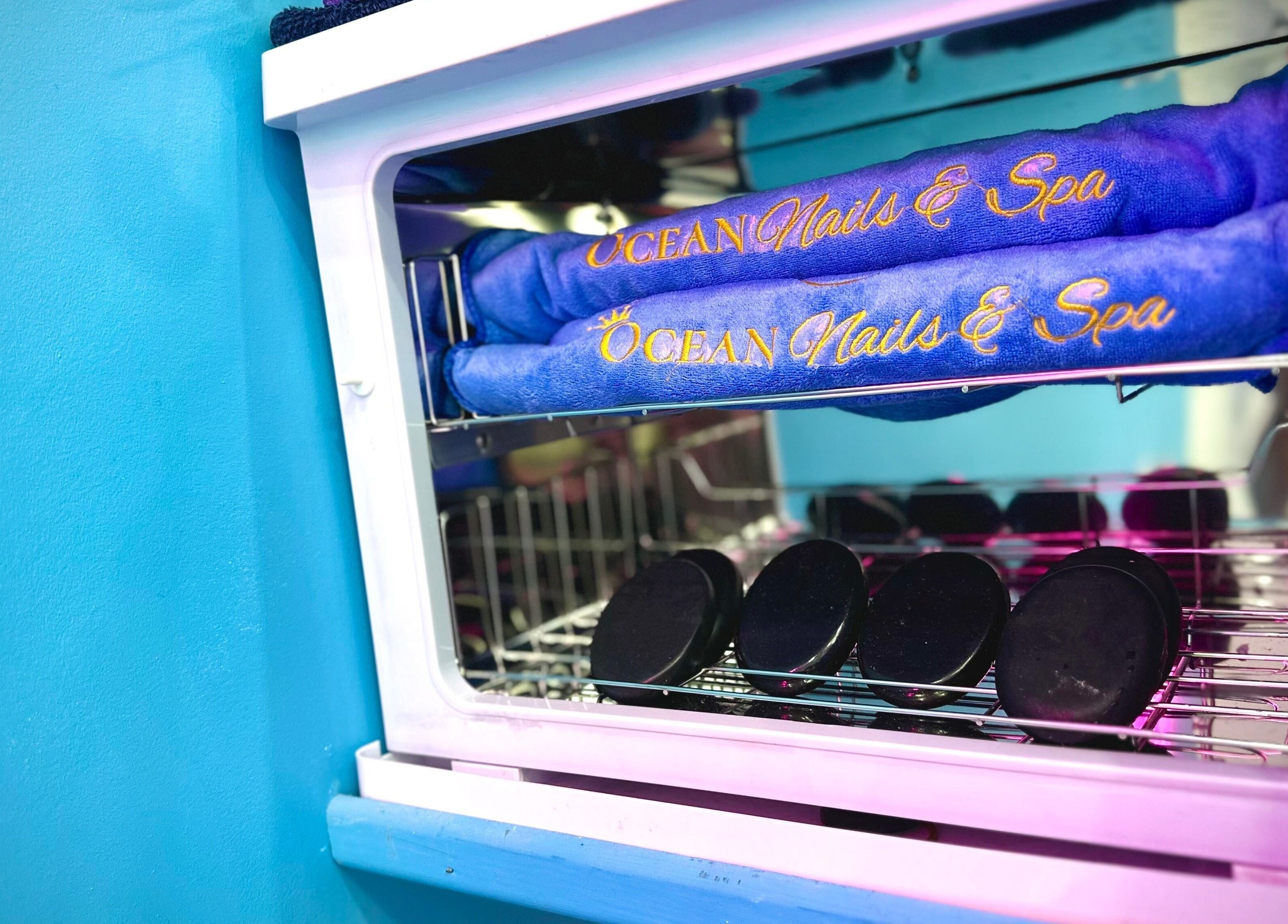 Ocean Nails Spa towels in a warmer at Airdrie, Scotland, GB venue, enhancing relaxation and wellness experience.