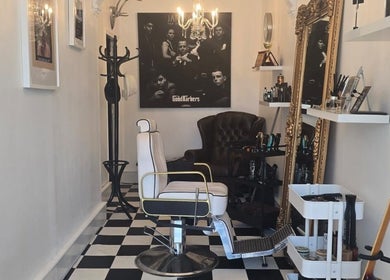 Elegant barber interior at THE SANDBANKS BARBER COMPANY, Poole, England, GB with vintage decor and stylish seating.