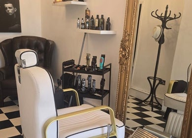 Chic barbershop interior at THE SANDBANKS BARBER COMPANY in Poole, England, GB with vintage decor and grooming tools.