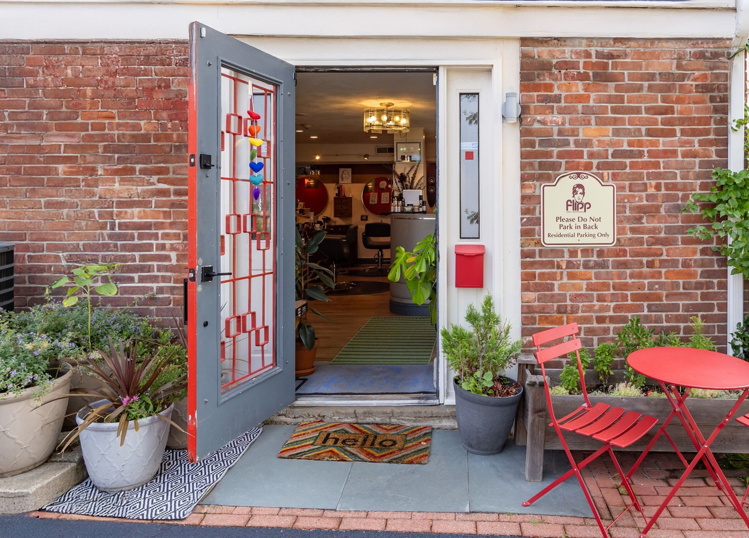 Welcoming entrance of Flipp Salon and Apothecary in Providence, Rhode Island with open door and cozy decor.