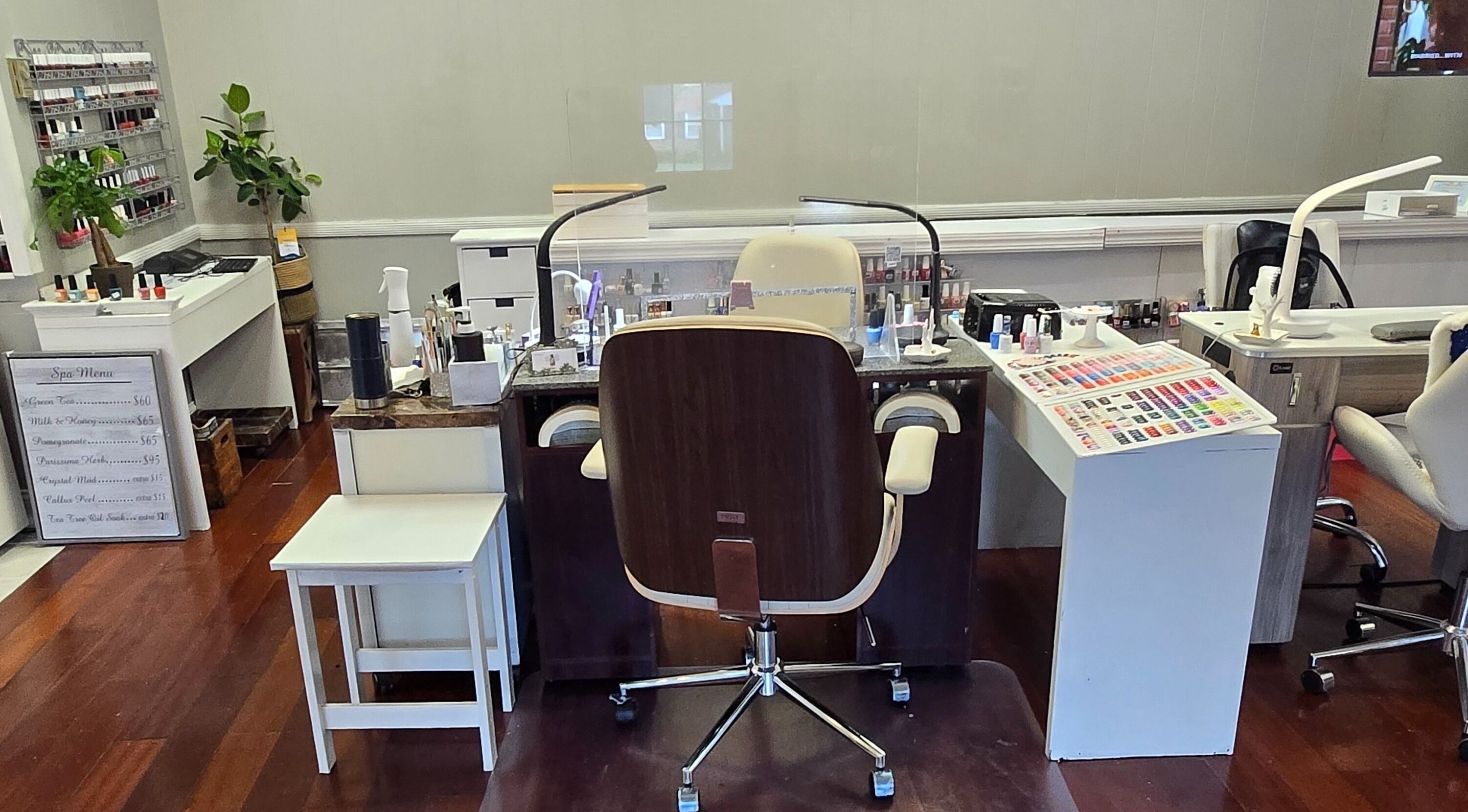 Nail Club&Spa's cozy nail station in West Caldwell, New Jersey, US with polish selection and spa menu.