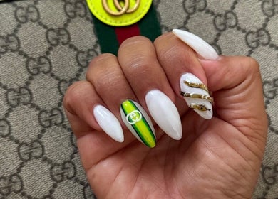 Stylish nail art at Nail Club&Spa in West Caldwell, New Jersey, US with white and green accents.
