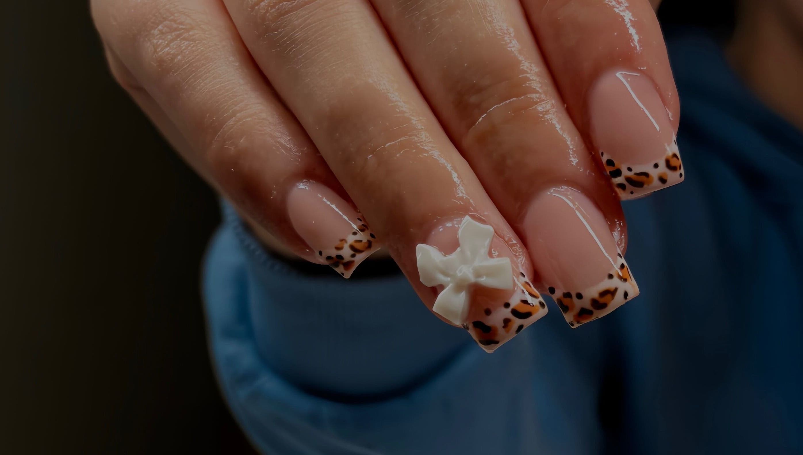 Elegant nail design with bow detail at Cullen & Co, Mullingar, County Westmeath, IE.