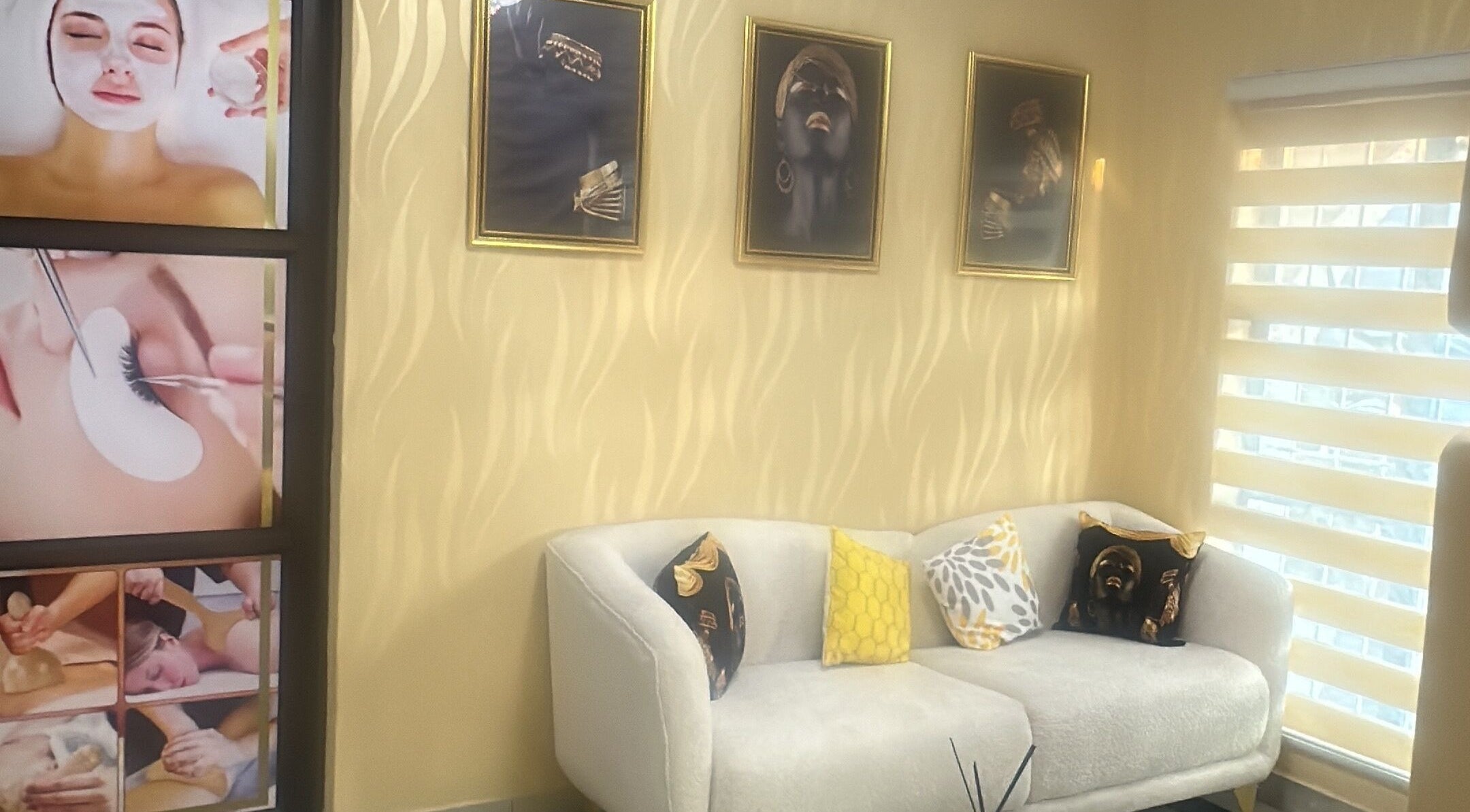 Relaxing seating area at Glamour Haven Beauty, Johannesburg, Gauteng, ZA with elegant wall art and plush sofa.