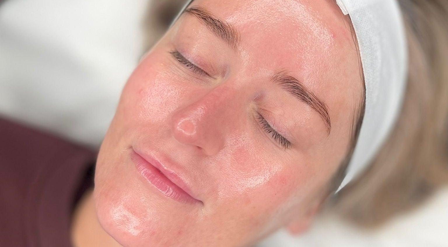 Close-up of a serene face with glowing skin during a facial at Glow By Molly, Tywyn, Wales, GB.