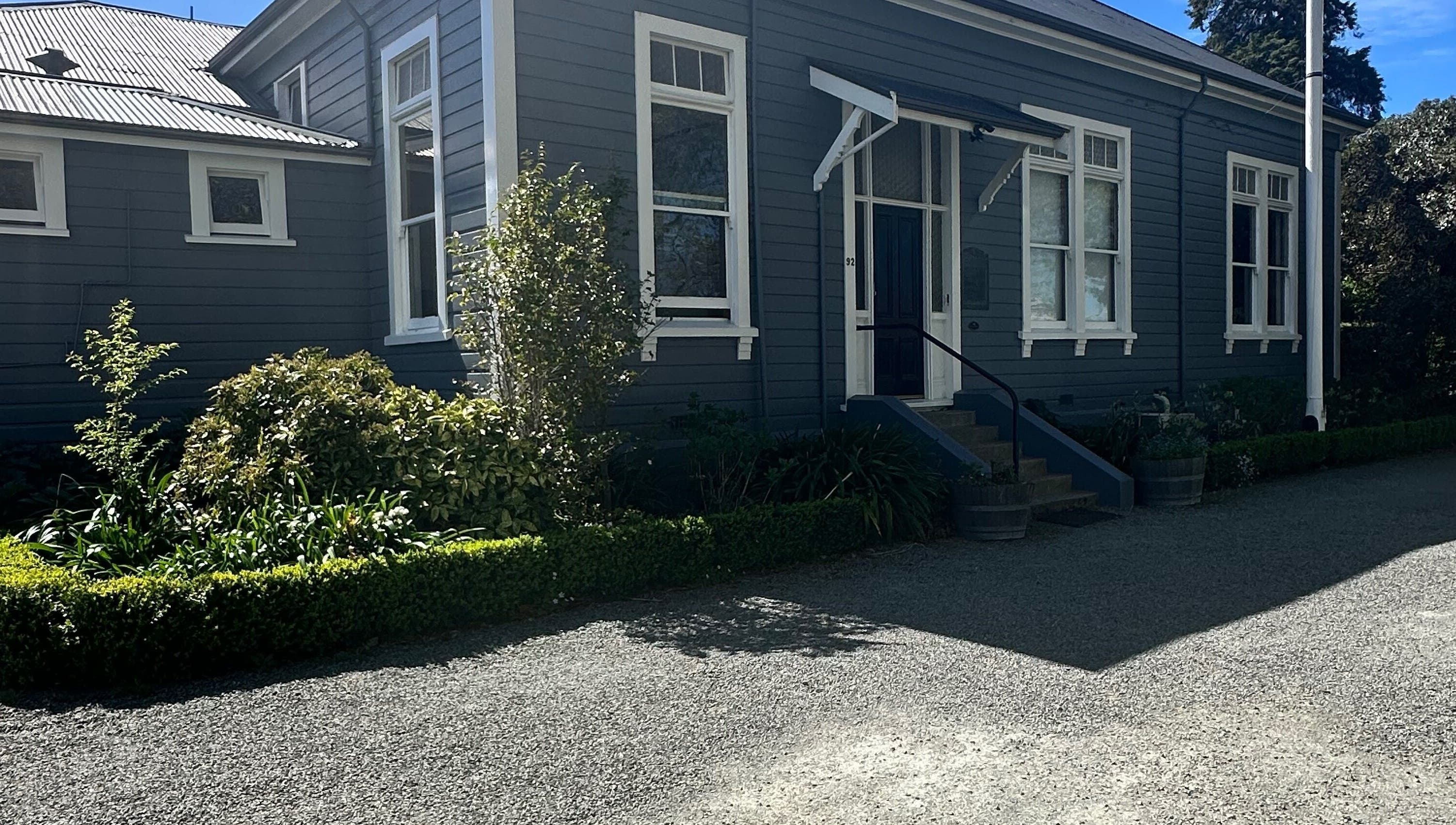 Front view of Alchemy Hair & Beauty in Blenheim, Marlborough Region, NZ with lush greenery.