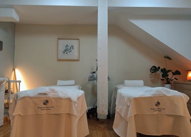 Relaxing therapy room at Meditation TaiChi TCM Health Centre in London, England, GB, with massage tables.