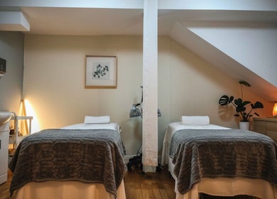 Elegant massage room at Meditation TaiChi TCM Health Centre, London, England, GB. Cozy, peaceful ambiance with two tables.