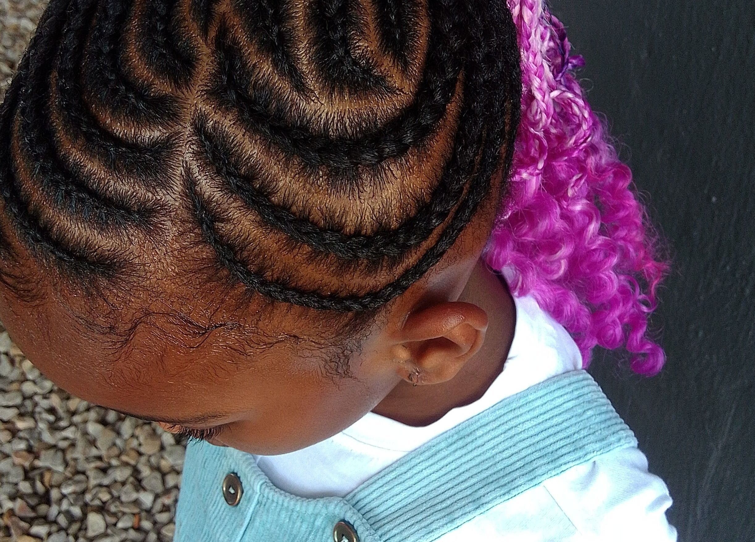 Colorful braided hairstyle for kids at Nthaby Pretty Kids Salon in Pretoria East, Gauteng, ZA.