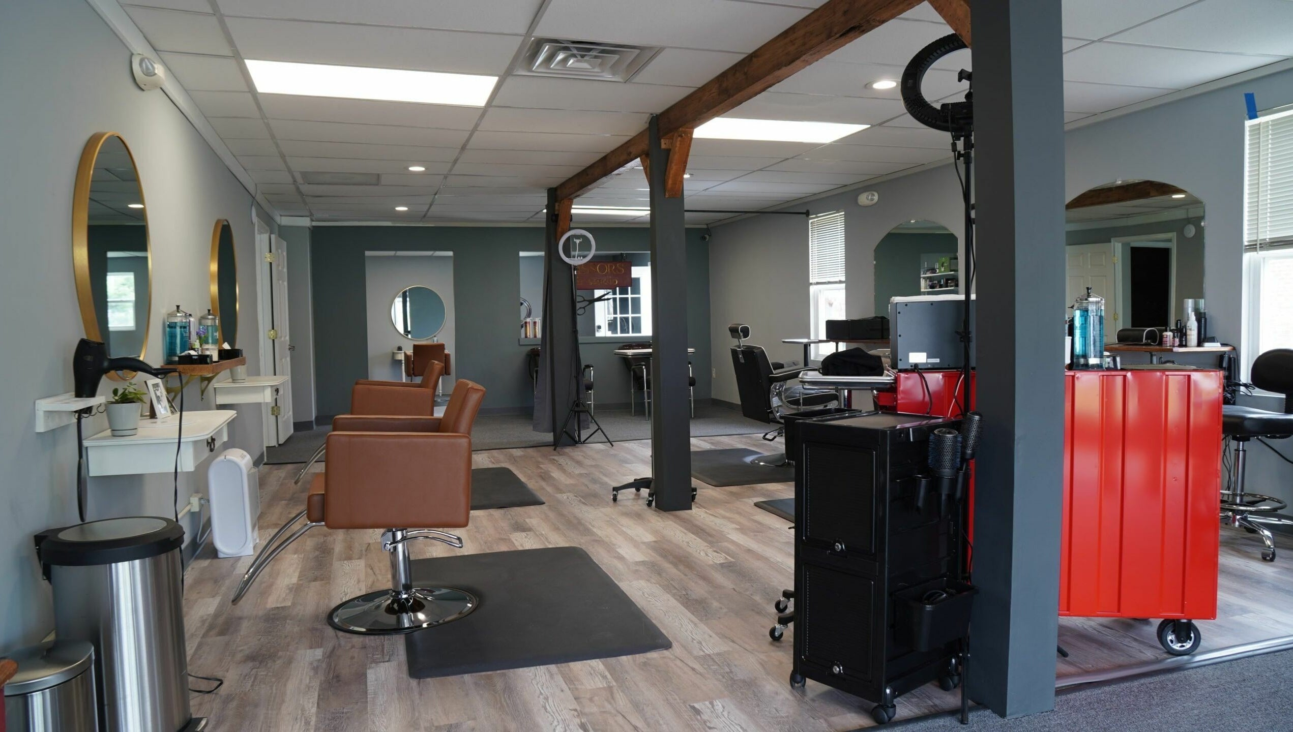 Modern interior of Scissors Hair and Barber in New Freedom, Pennsylvania, US, showcasing chic workstations.