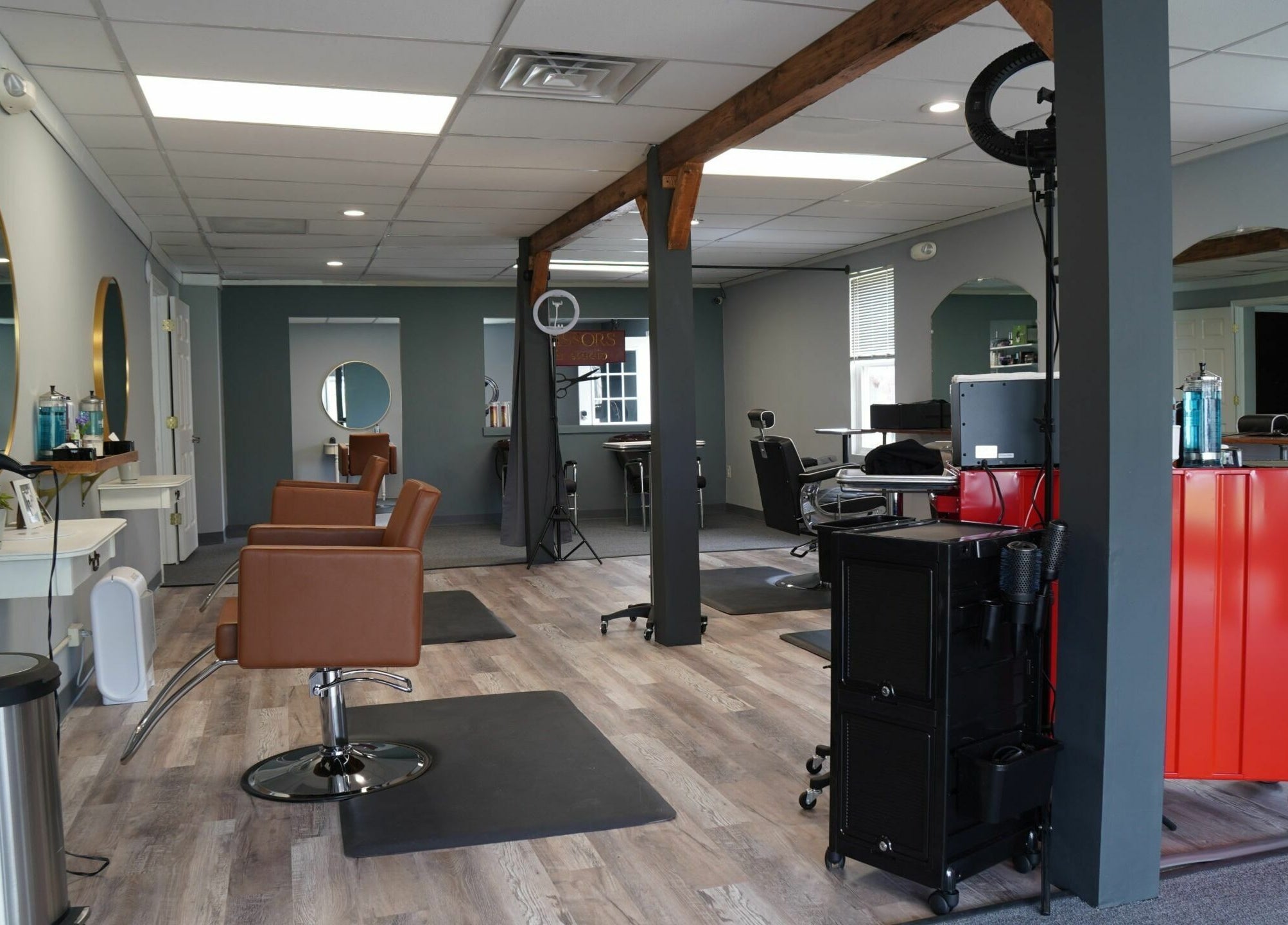 Modern interior of Scissors Hair and Barber in New Freedom, Pennsylvania, US, showcasing chic workstations.