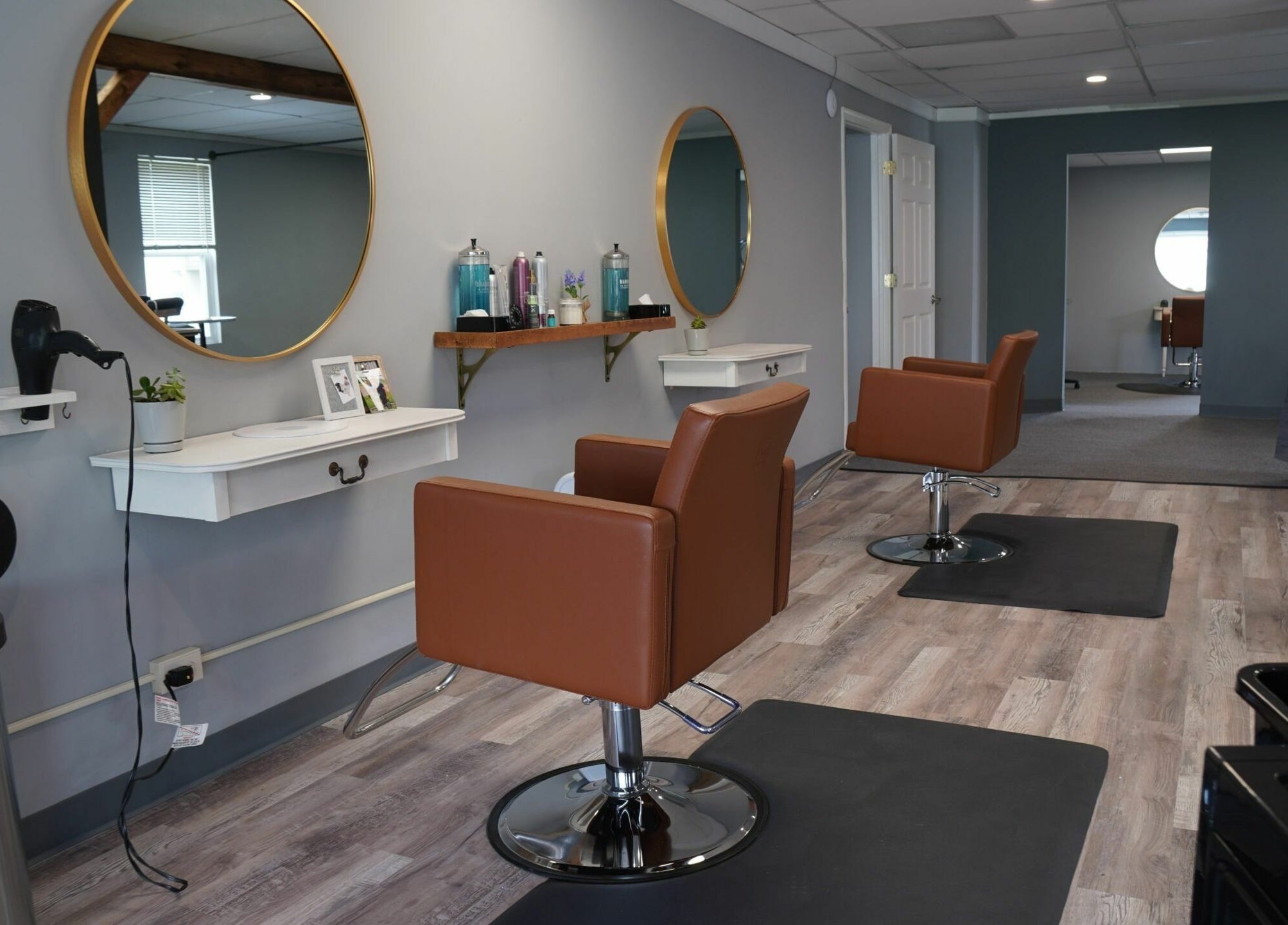 Modern salon interior at Scissors Hair and Barber, New Freedom, Pennsylvania, US, featuring stylish chairs and mirrors.
