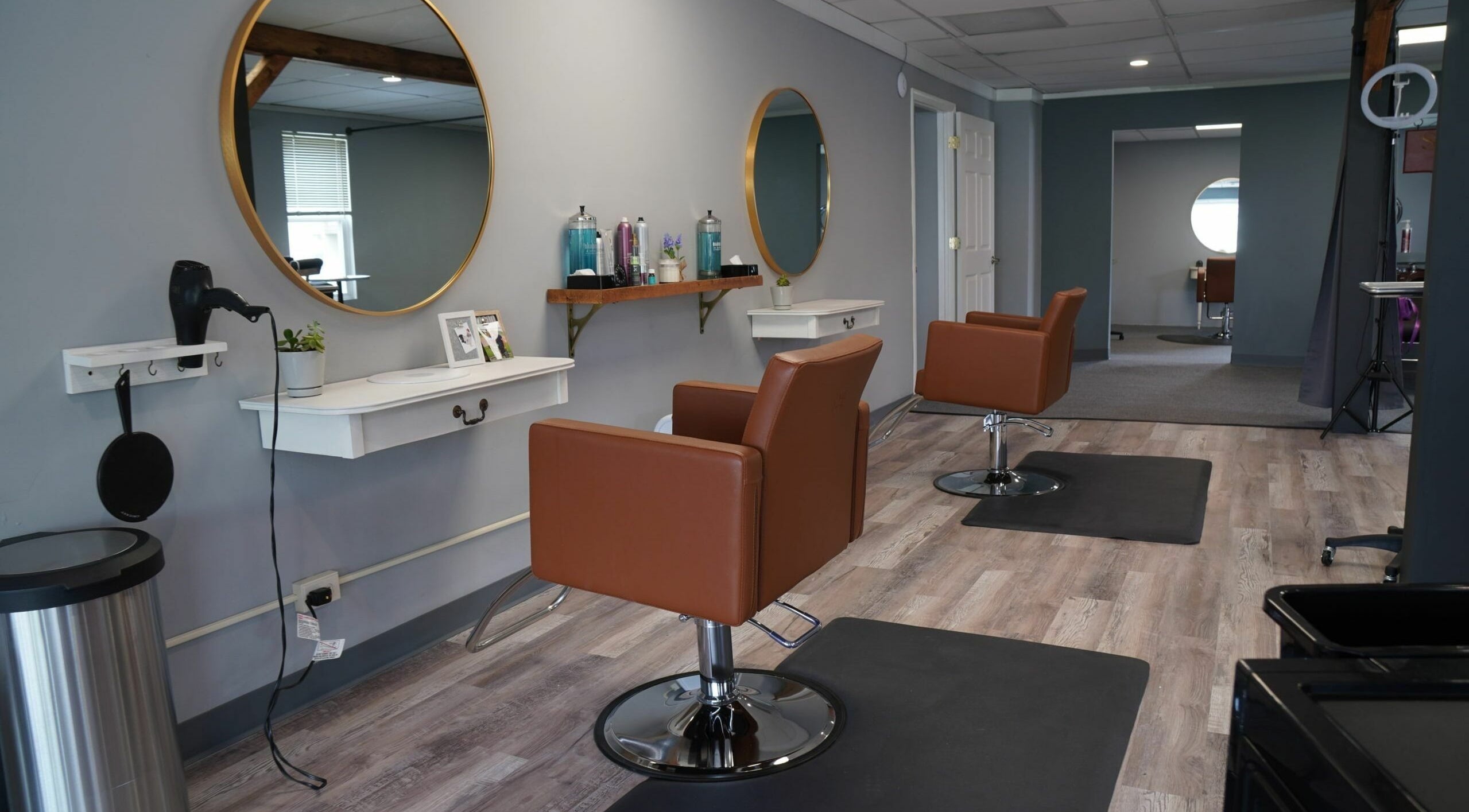Modern salon interior at Scissors Hair and Barber, New Freedom, Pennsylvania, US, featuring stylish chairs and mirrors.