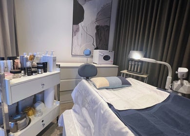 Relaxing treatment room at Skiness, West Hollywood, California, US, equipped with skincare products and modern decor.