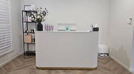 Reception area at Cascade Hair Extensions, Mount Warren Park, Queensland, featuring a sleek white desk and product display.