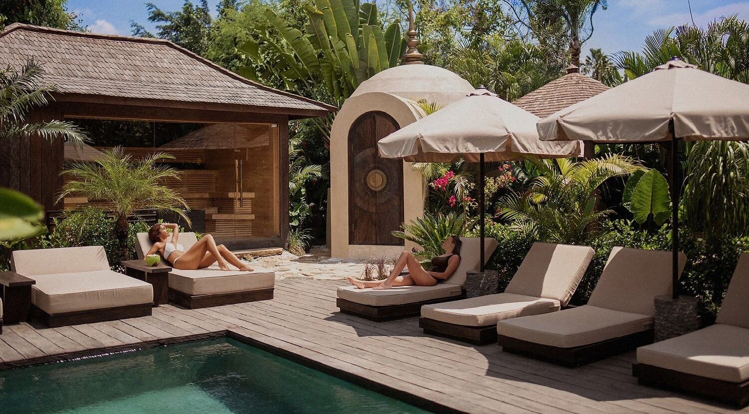 Relax by the pool at The Ark | Social Recovery Club in Bali, Bali, ID, surrounded by lush tropical greenery.