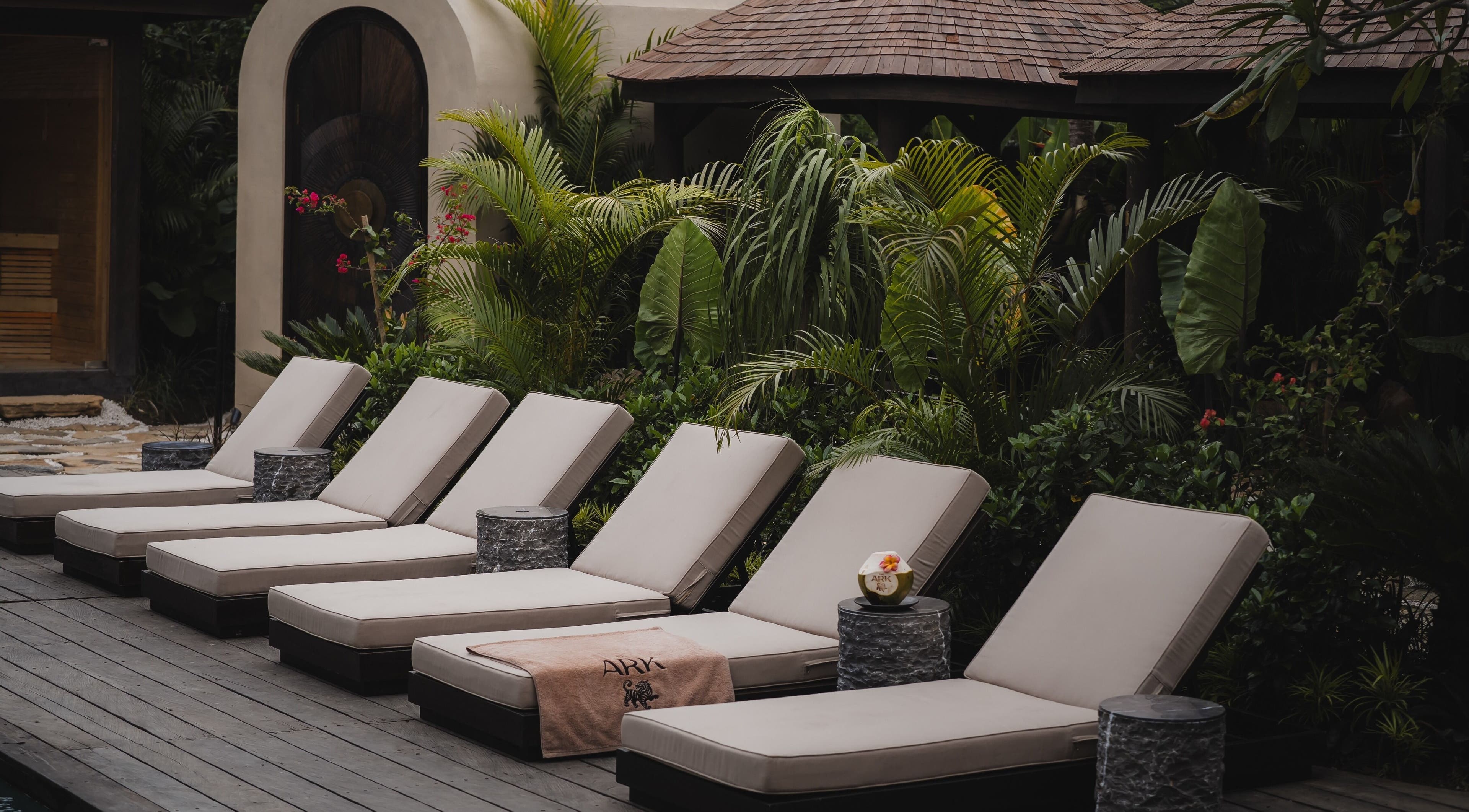 Luxurious lounge chairs at The Ark | Social Recovery Club, Bali, Bali, ID, set in lush tropical surroundings.