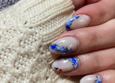 Elegant blue and white nail art from SassyGoose, Bloemfontein, Free State, ZA, showcasing creativity and style.